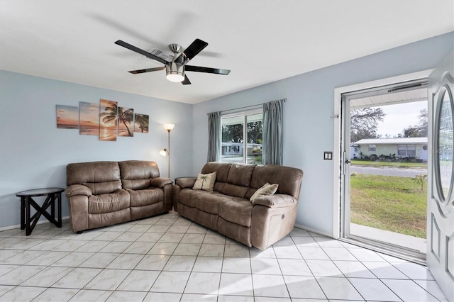 tiled living room featuring ceiling fan and a wealth of natural light