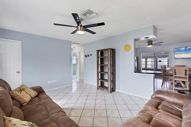 tiled living room with ceiling fan