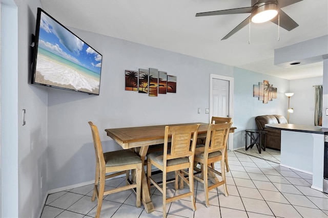 tiled dining area featuring ceiling fan