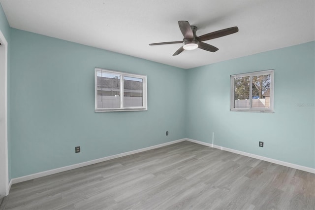 empty room with ceiling fan and light hardwood / wood-style floors