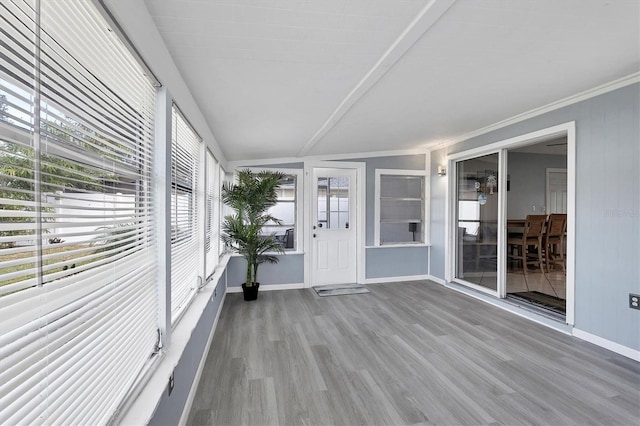 unfurnished sunroom with lofted ceiling with beams