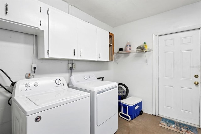 washroom with cabinets and washer and clothes dryer