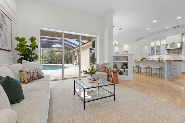 living area with lofted ceiling, a sunroom, light tile patterned floors, and recessed lighting