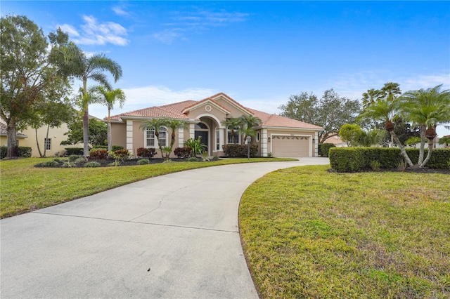 mediterranean / spanish-style home with a garage, concrete driveway, a tiled roof, stucco siding, and a front lawn