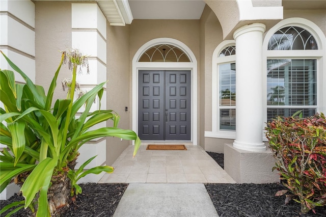 property entrance with stucco siding