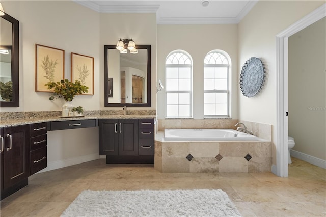 full bathroom featuring vanity, a garden tub, toilet, and crown molding