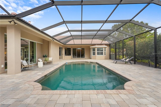 outdoor pool featuring a lanai and a patio