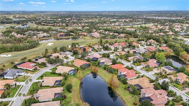 drone / aerial view featuring a residential view, a water view, and golf course view