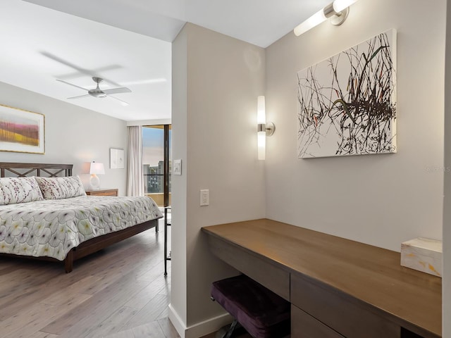 bedroom with floor to ceiling windows, ceiling fan, and light hardwood / wood-style floors