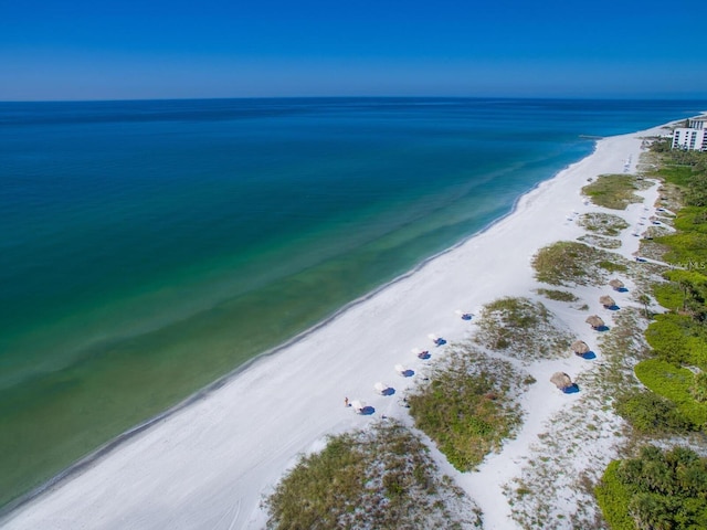 aerial view featuring a water view and a view of the beach