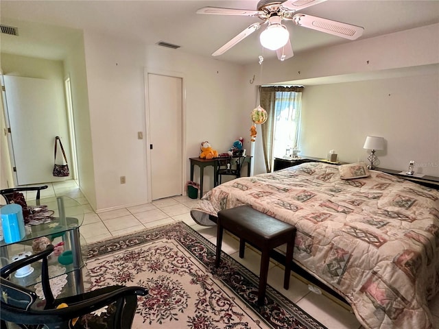 tiled bedroom featuring ceiling fan