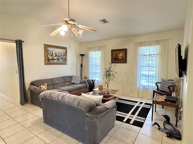 tiled living room featuring ceiling fan and lofted ceiling