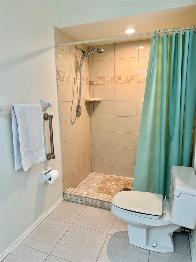 bathroom with tile patterned floors, a shower with curtain, and toilet