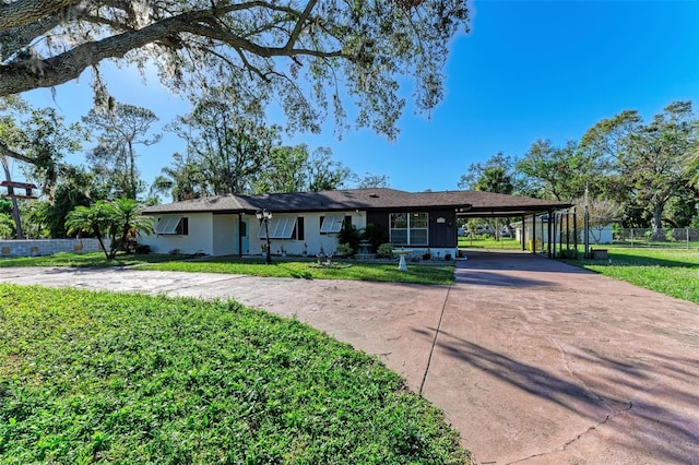 ranch-style home featuring a front yard and a carport