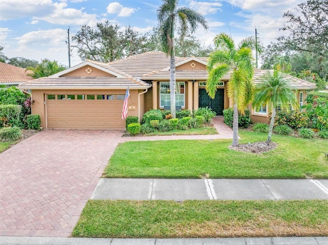 view of front of property with a front lawn and a garage