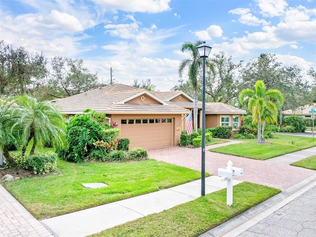 ranch-style house featuring a garage and a front lawn