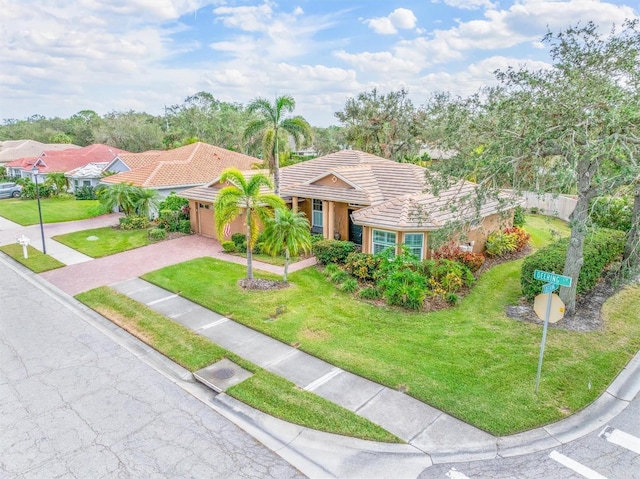 view of front of property featuring a garage and a front lawn