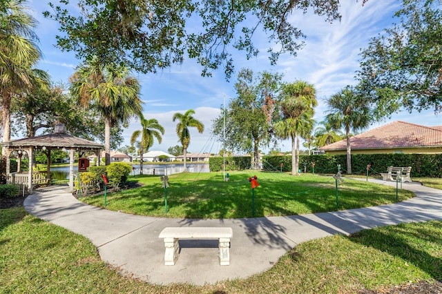 view of home's community with a gazebo, a lawn, and a water view