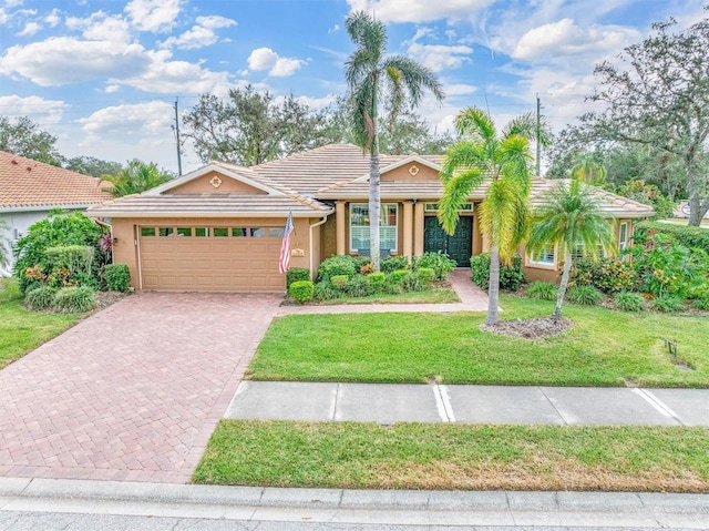 view of front of house featuring a garage and a front lawn