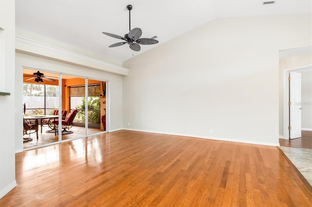 unfurnished living room featuring ceiling fan, lofted ceiling, and light hardwood / wood-style floors