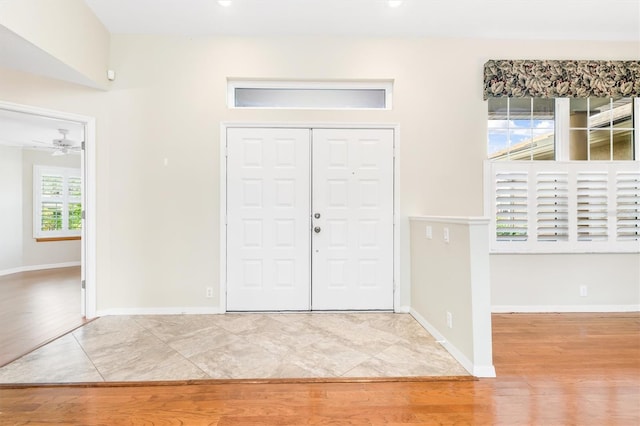 foyer entrance featuring light hardwood / wood-style floors and ceiling fan