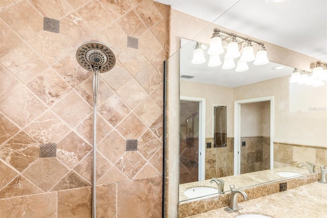 bathroom with vanity and tiled shower