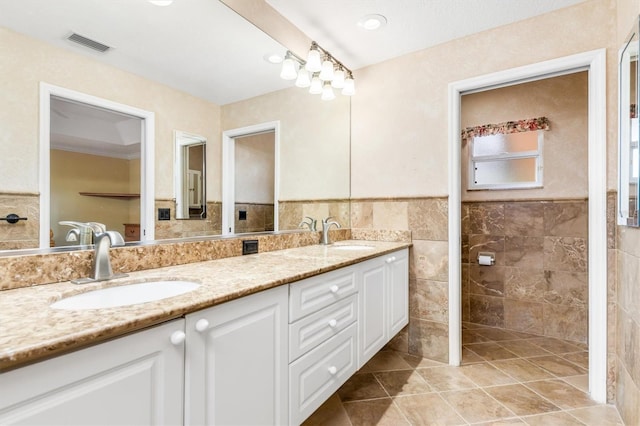 bathroom featuring vanity, tile walls, and tile patterned floors