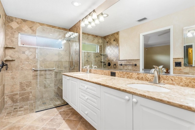 bathroom with vanity, tile walls, and a tile shower