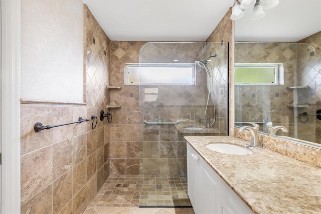 bathroom with vanity and tiled shower