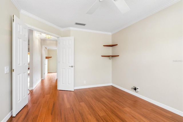 spare room with hardwood / wood-style flooring, ceiling fan, and ornamental molding