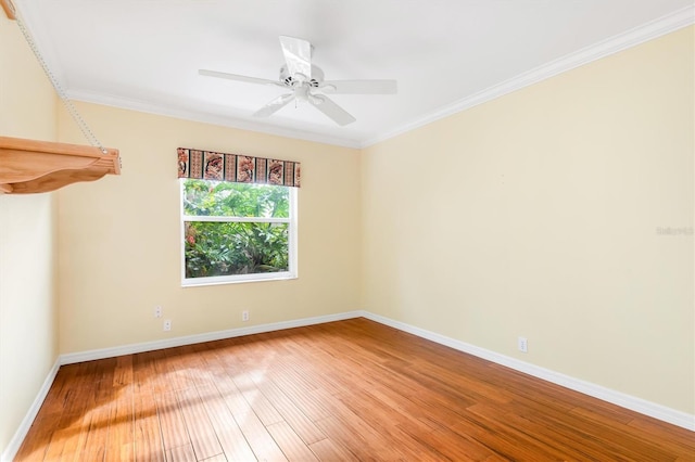 spare room with hardwood / wood-style flooring, ornamental molding, and ceiling fan