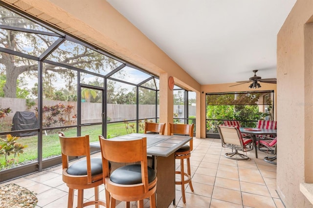 sunroom featuring ceiling fan