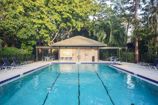 community pool featuring a patio and fence