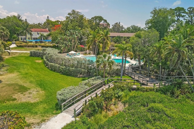 view of community with a swimming pool and a yard