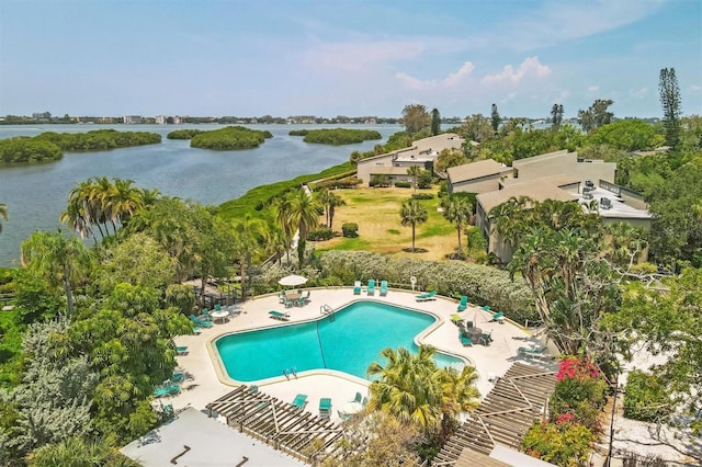 community pool with a patio area and a water view