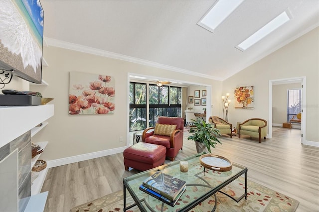 living room featuring baseboards, vaulted ceiling with skylight, wood finished floors, and crown molding