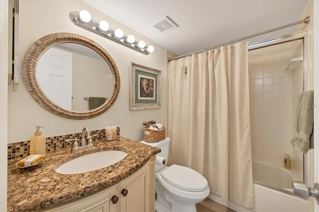 full bath featuring vanity, visible vents, shower / bath combo with shower curtain, toilet, and tasteful backsplash