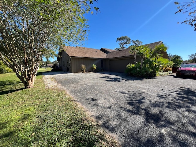 view of property exterior featuring a garage and a yard