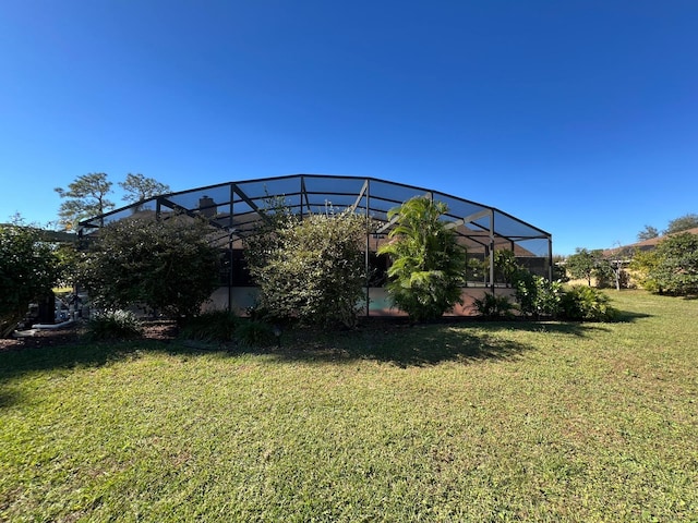 view of yard with glass enclosure