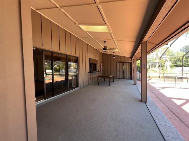 view of patio / terrace with ceiling fan and a lanai