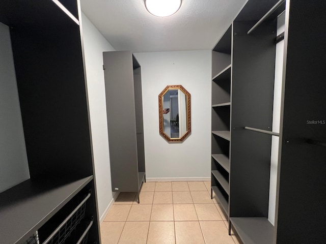 spacious closet featuring light tile patterned flooring