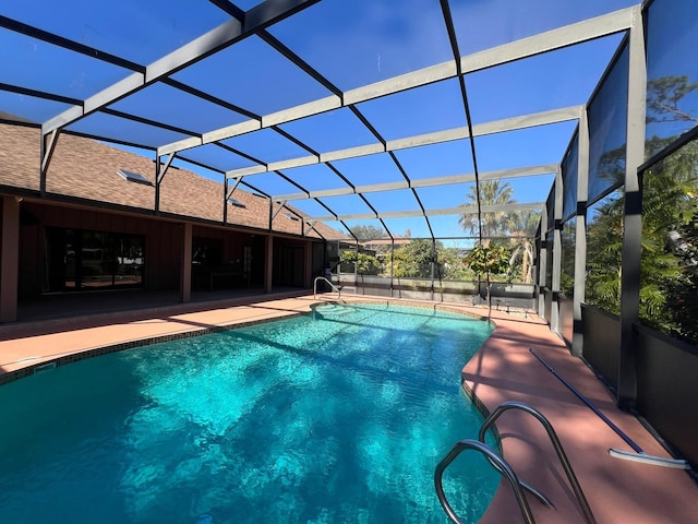 view of swimming pool featuring a lanai and a patio area