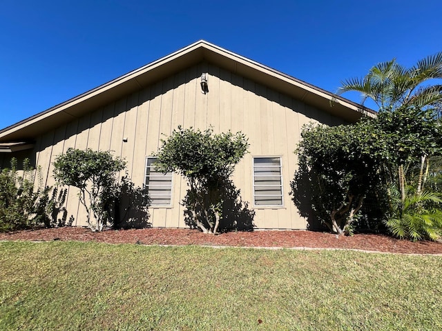 view of side of home featuring a lawn