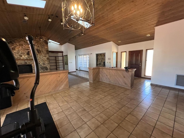 kitchen featuring a chandelier, wood ceiling, and vaulted ceiling with skylight