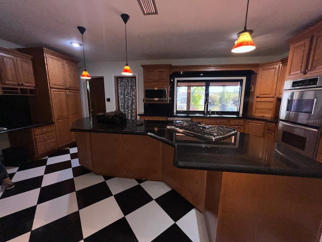 kitchen featuring hanging light fixtures, a center island, stainless steel appliances, and sink