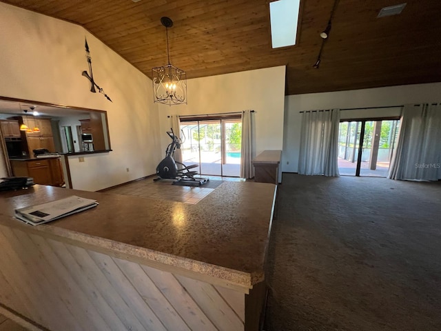 kitchen featuring wood ceiling, hanging light fixtures, high vaulted ceiling, and an inviting chandelier