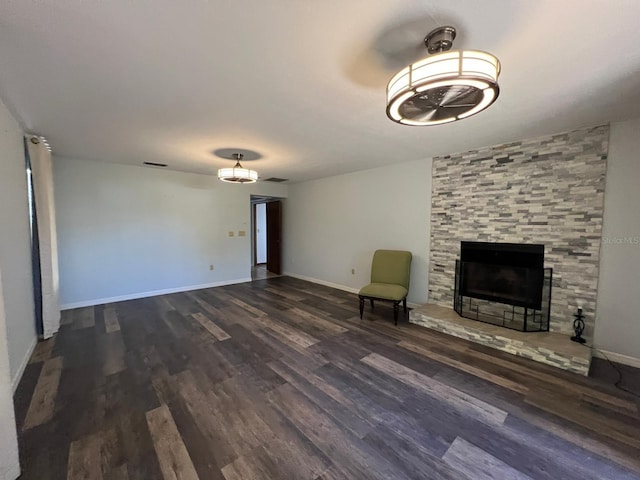 unfurnished living room with a fireplace and dark wood-type flooring