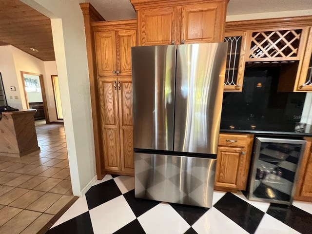 kitchen featuring beverage cooler and stainless steel refrigerator