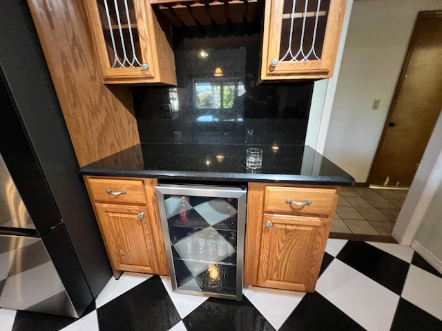 kitchen featuring tasteful backsplash, wine cooler, light tile patterned floors, and fridge