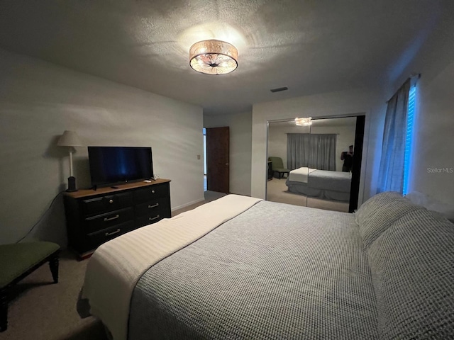 carpeted bedroom with a textured ceiling